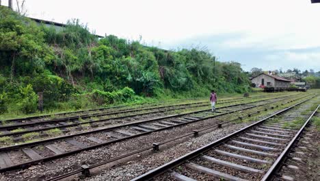 man walking on train tracks in sri lanka