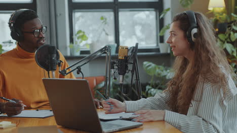 young man and woman hosting podcast together in recording studio