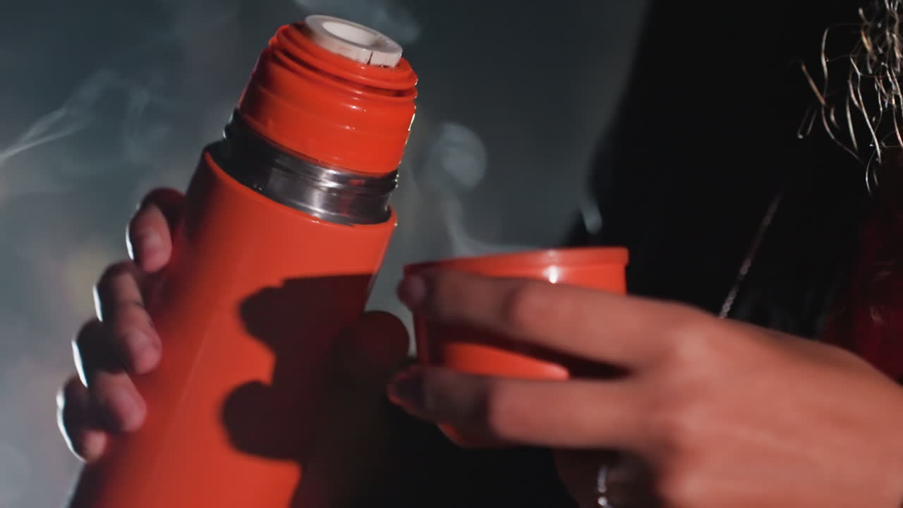 Nighttime beverage pleasure. Savoring hot drink under stars. Person relishes warm beverage beneath starry night sky. Individual enjoys hot drink while gazing at luminous stars above