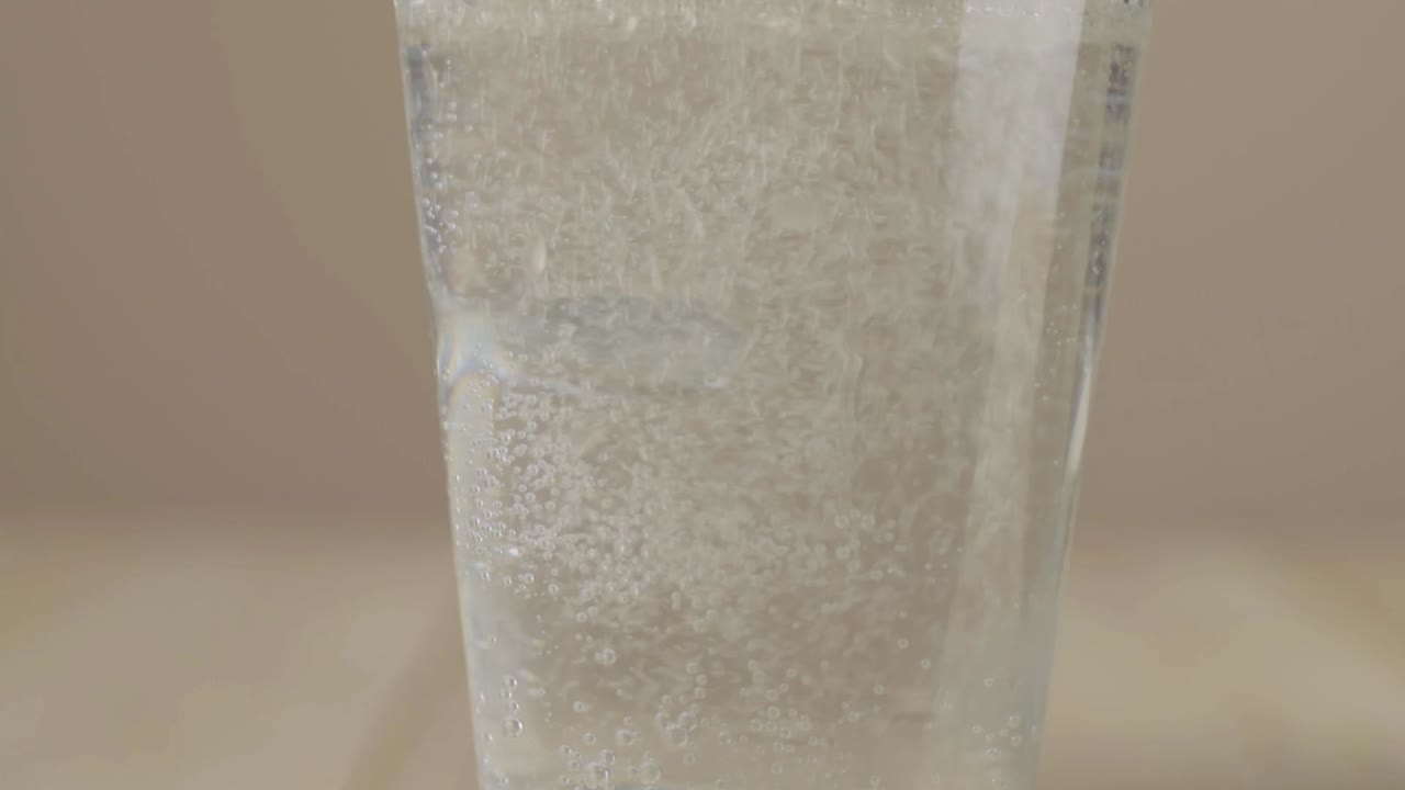 Pouring glass of fresh fizzy water