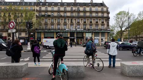 people and vehicles at a paris street crossing