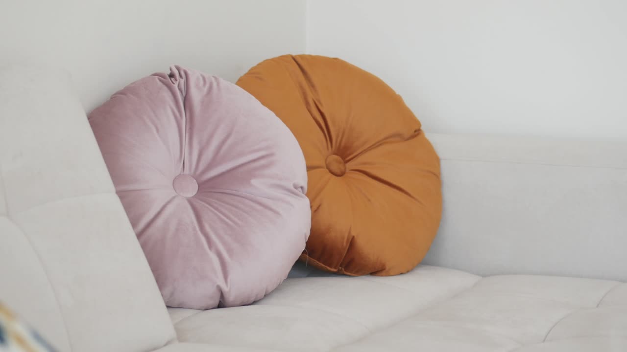 Round Velvet Pillows on a White Sofa