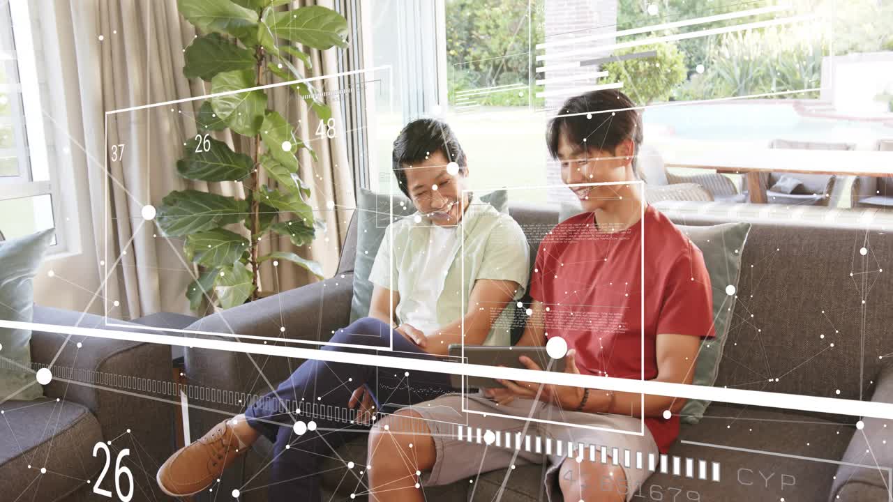 Teenage boy tapping tablet, mid-adult man leaning in, exploring AR tech with shifting numeric grids