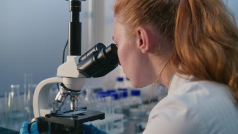 scientist using microscope in a laboratory