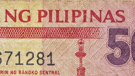 macro pan over filipino “republika ng pilipinas” text on a philippine peso note