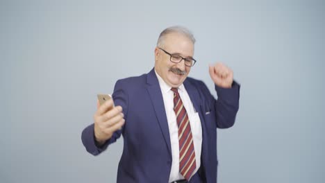 businessman dancing with phone in hand.