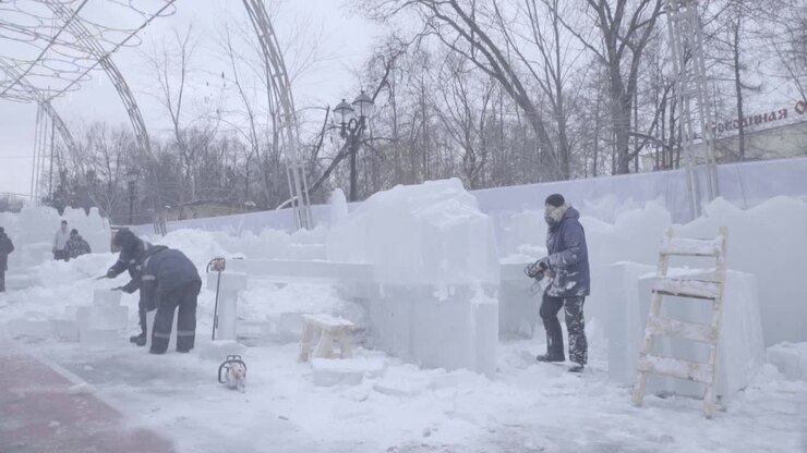 Ice Sculptures Being Constructed in a Winter Park