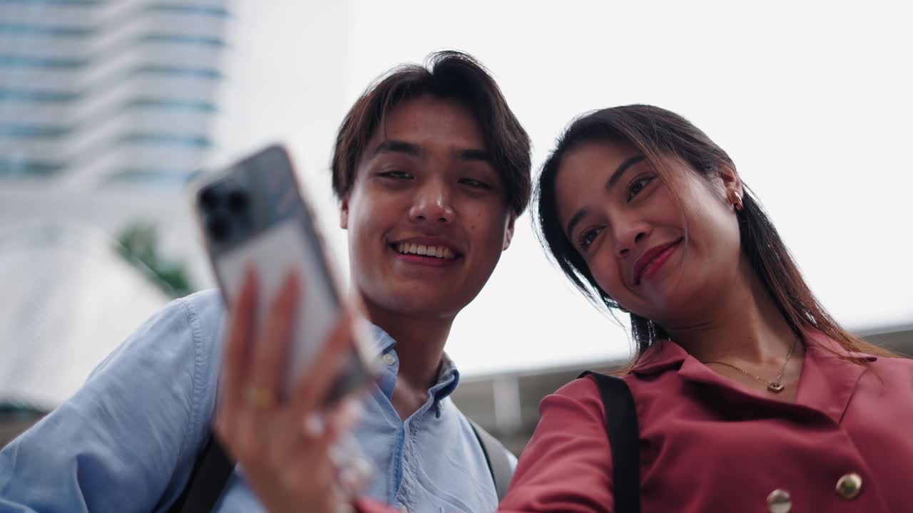 Couple taking a selfie in a city