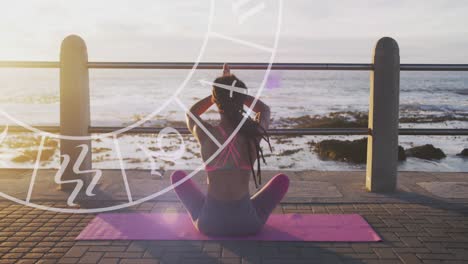 Horoscope-circle-against-rear-view-of-african-american-fit-woman-performing-yoga-on-the-promenade