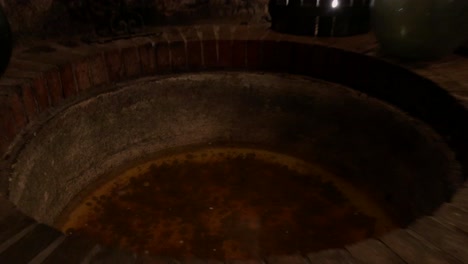 Woman-looking-at-an-underground-water-well-1