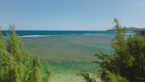 aerial revealing amazing natural pools of clear crystal water, formed at low tide on coral reefs in anini beach, kauai, hawaii