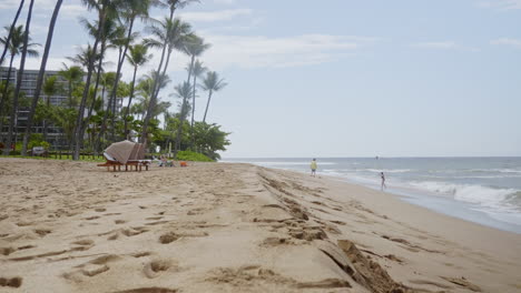 a static view of tourists enjoying a sandy beach during a vacation in the evening under a cloudy sky