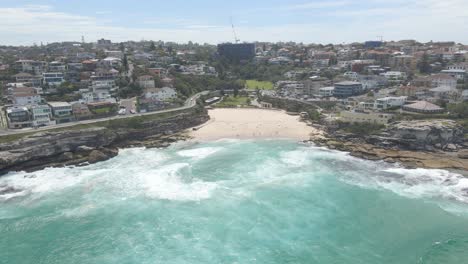 narrow beach of tamarama in mackenzies bay with eastern suburbs in background, sydney, new south wales, australia