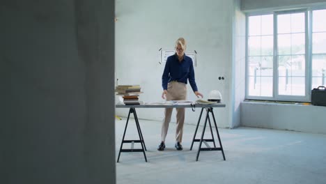 interior designer reviewing plans at a construction site