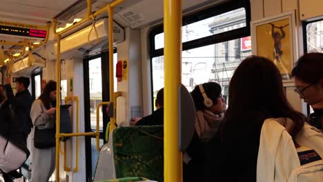 people interacting inside a moving tram