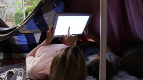 sisters under sheets forming a tent