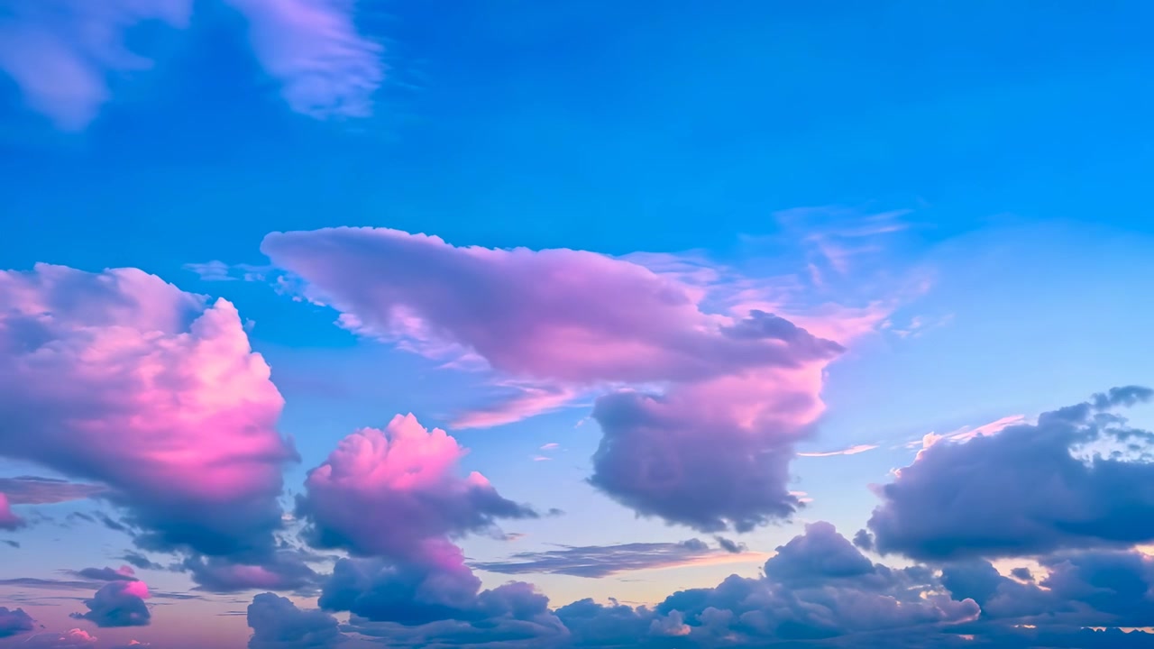 Vibrant Pink and Blue Sunset Clouds Moving Across the Sky