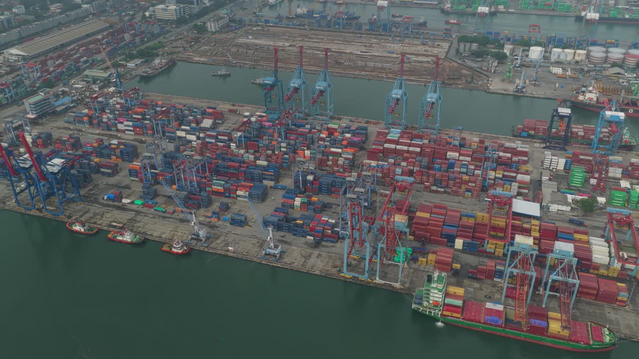 Industrial harbor at Tanjung Priok with container yard and ships, Jakarta