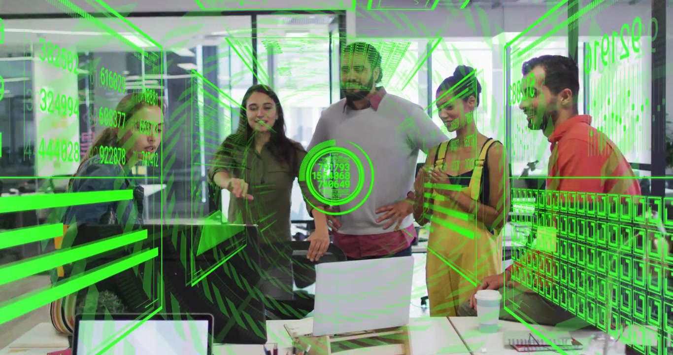Team standing around desk, colleague gesturing to activate AR data overlays for business analysis