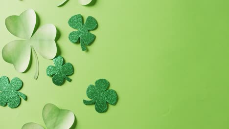 Video-of-saint-patricks-day-green-shamrock-leaves-with-copy-space-on-green-background