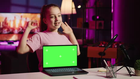 child tech content creator filming technology review of green screen laptop