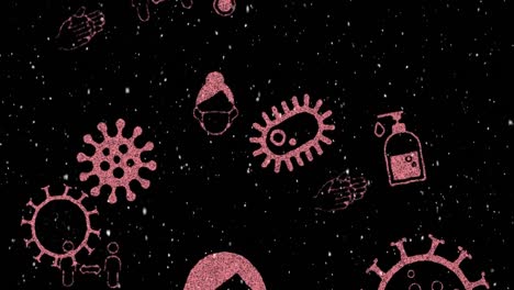 Animation-of-pink-covid-19-cells-and-icons-moving-over-winter-scenery-snow-falling-on