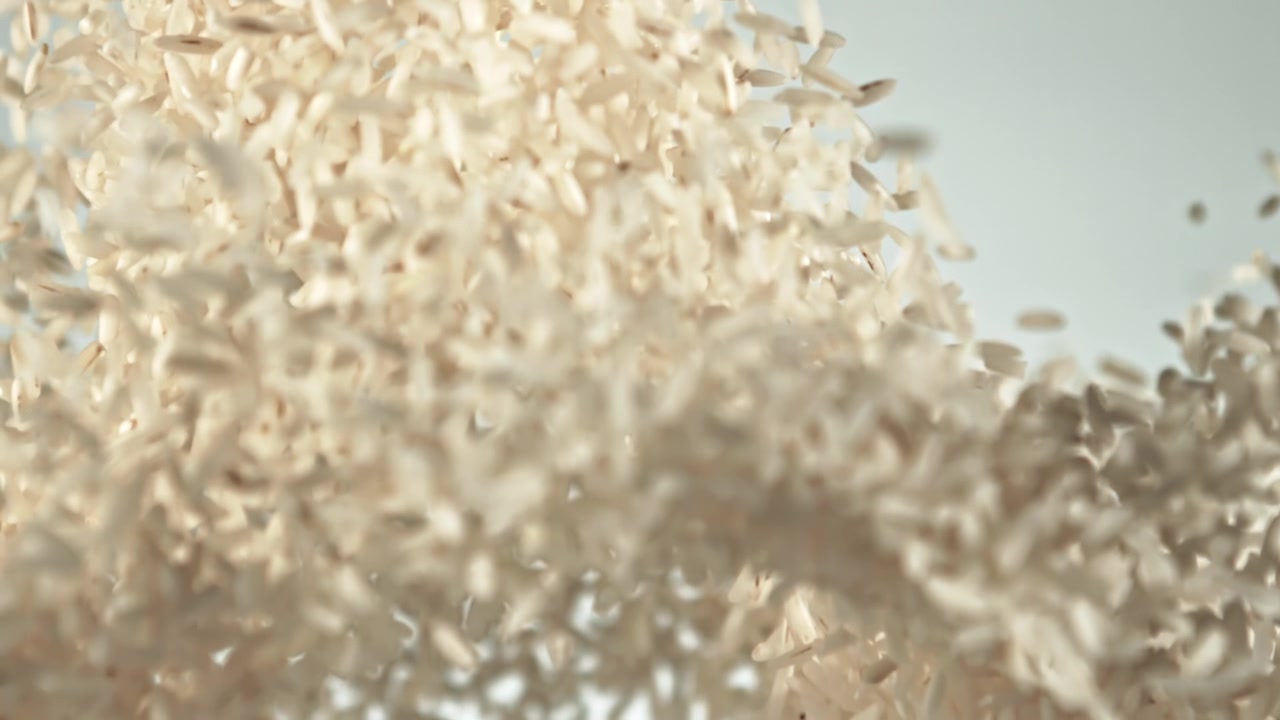 Raw Rice Grains Falling and Scattering in Slow Motion