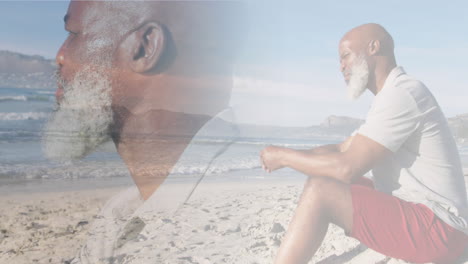 compuesto de un anciano afroamericano pensativo sentado en la playa y mirando hacia el mar
