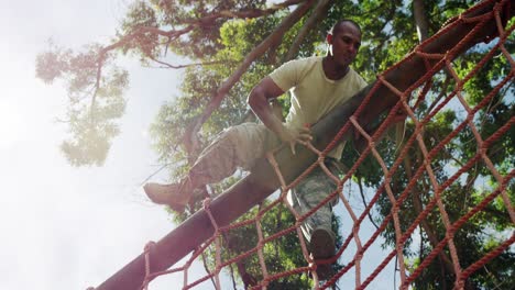 Military-soldier-climbing-a-net-during-obstacle-course-4k