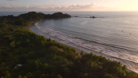 aerial view of an uninhabited beach and forest at sunset in costa rica