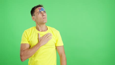man listening to the australia national anthem with solemnity