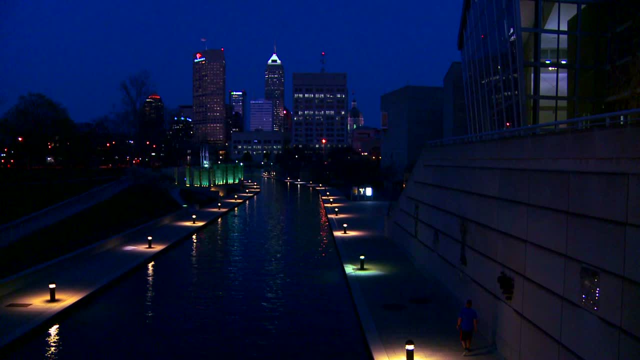 The city of Indianapolis Indiana at night with the White River foreground