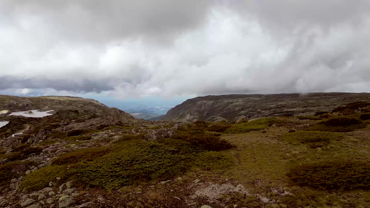 An aerial drone captures rapid-motion footage of the highest peak in Portugal's Serra de Estrella mountain range
