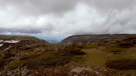 an aerial drone captures rapid-motion footage of the highest peak in portugal's serra de estrella mountain range