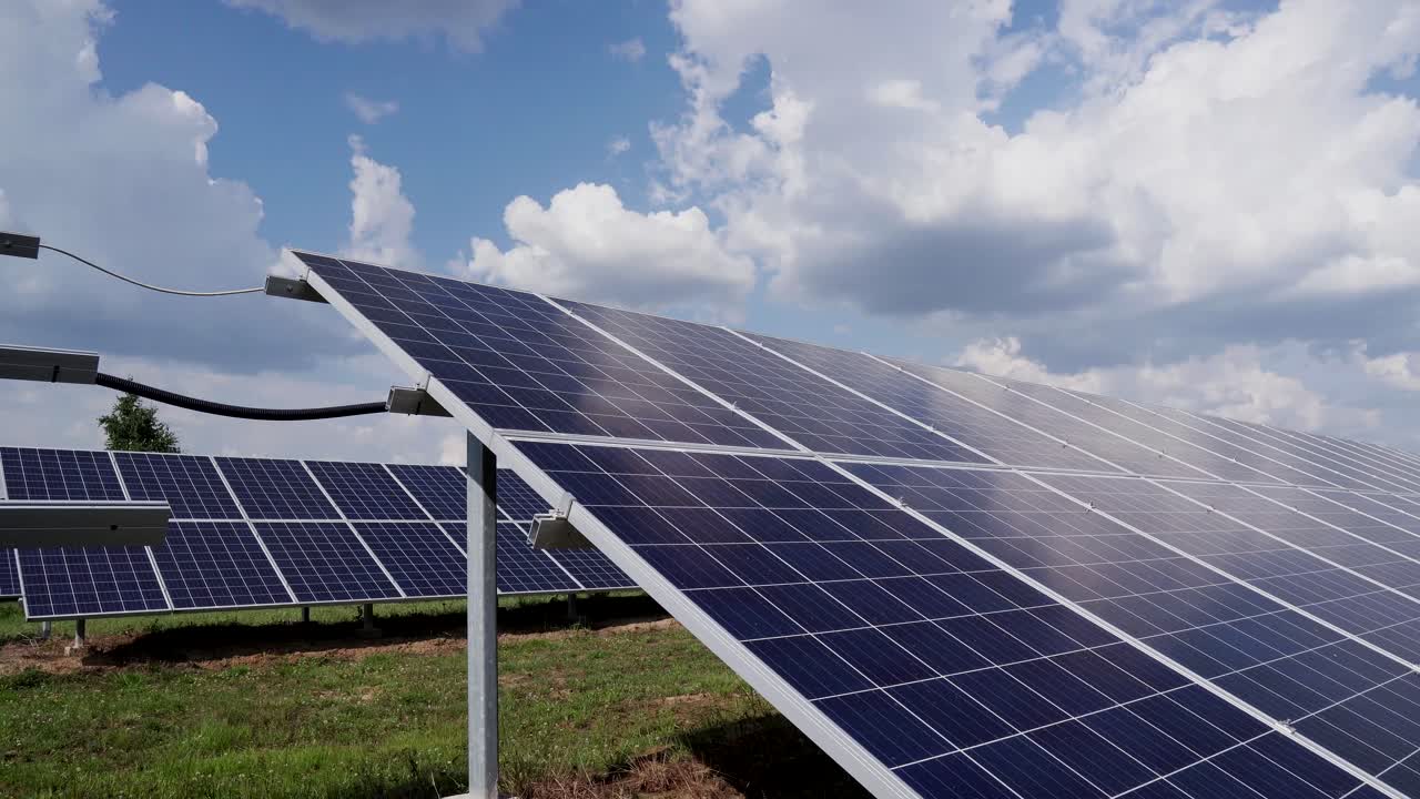 2 rows of solar silicon panels on a background of blue sky with clouds. Solar Power Station