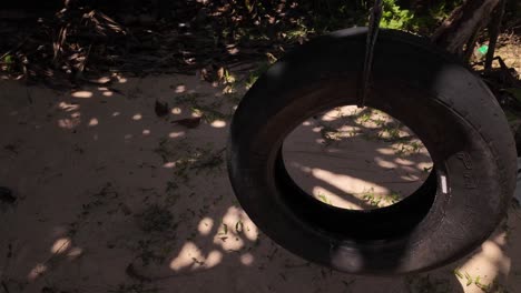 tire swing on the beach, leisure holiday relaxation swinging seat over sand