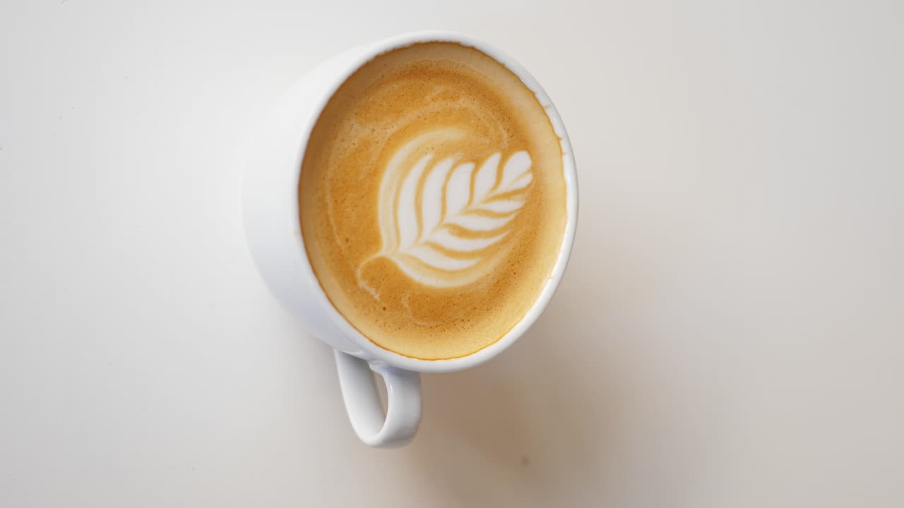 4K VERTICAL, Coffee Stir Reverse Effect to Reveal Milk Design, Close Up
