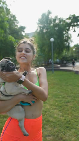 woman with pug in park