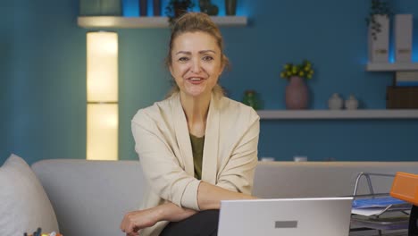 Mujer-Trabajadora-De-Oficina-En-Casa-Guiña-Un-Ojo-A-La-Cámara.