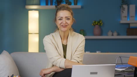 home office worker woman winks at camera.