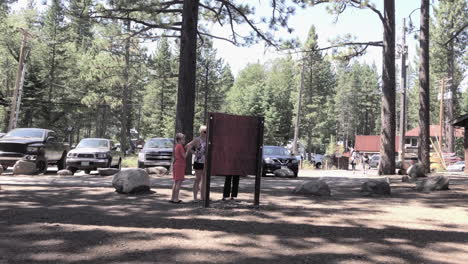 mother and sons read map near lake tahoe