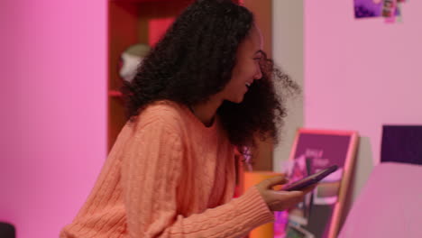 two friends looking at their phone in their room.