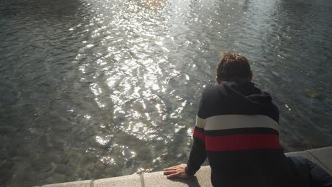 young man enjoying the canal in amsterdam