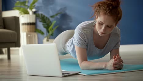 Tracking right video of woman doing plank at home