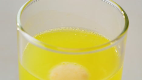 yellow drink with dissolving tablet