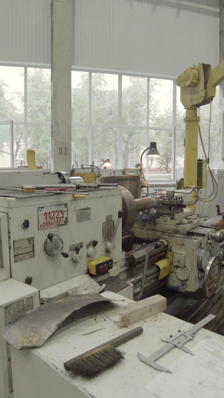 Worker operating a lathe machine