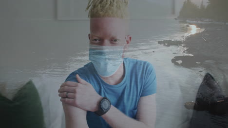 wearing mask and blue shirt, person with ocean waves animation overlaying scene