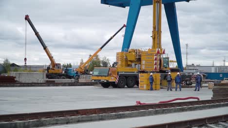 construction site with cranes and workers