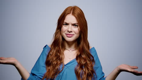 Worried-girl-looking-at-camera-in-studio.-Disappointed-woman-posing-indoors