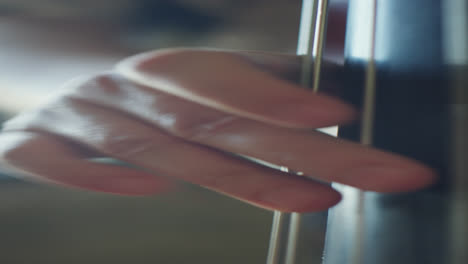 hands of double bass player plucking strings